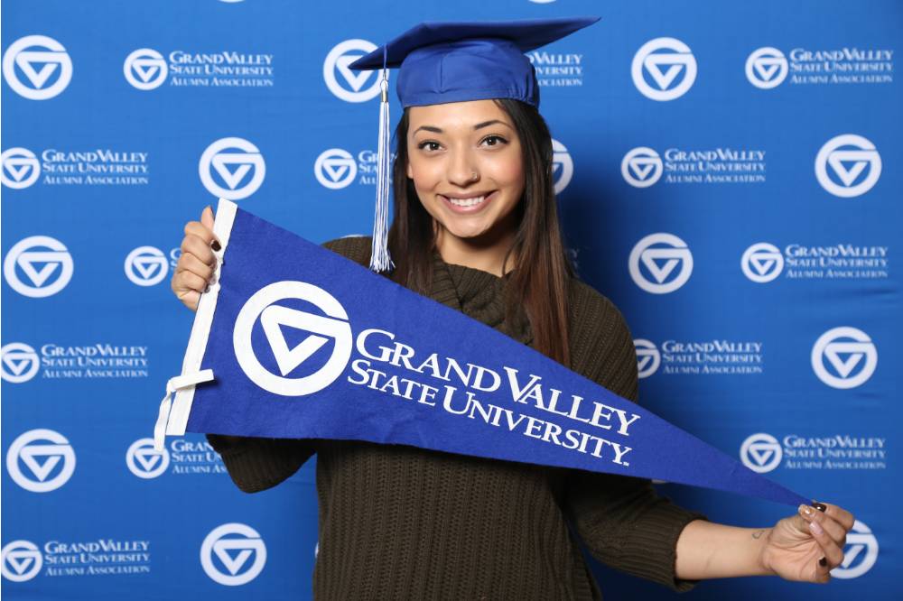 Future alumna poses with GV flag at Gradfest